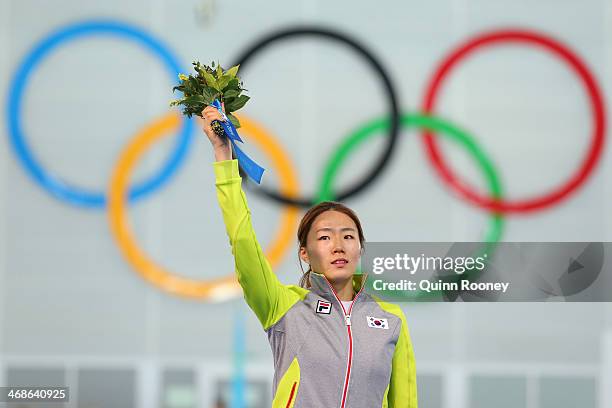 Gold medalist Sang Hwa Lee of South Korea celebrates on the podium during the flower ceremony for the Speed Skating Women's 500m Event during day 4...