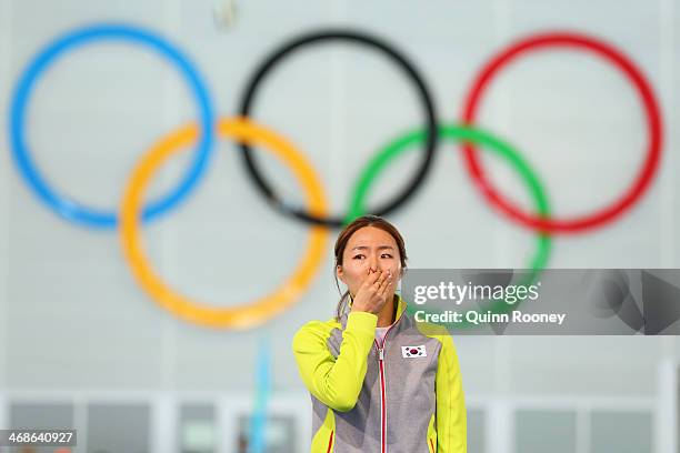 Gold medalist Sang Hwa Lee of South Korea celebrates on the podium during the flower ceremony for the Speed Skating Women's 500m Event during day 4...