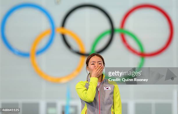Gold medalist Sang Hwa Lee of South Korea celebrates on the podium during the flower ceremony for the Speed Skating Women's 500m Event during day 4...