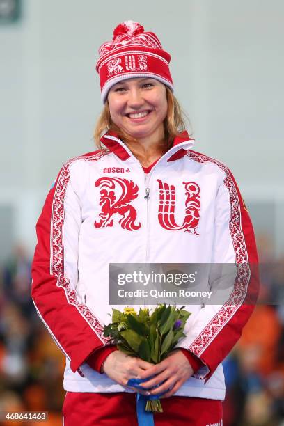 Silver medalist Olga Fatkulina of Russia celebrates on the podium during the flower ceremony for the Speed Skating Women's 500m Event during day 4 of...