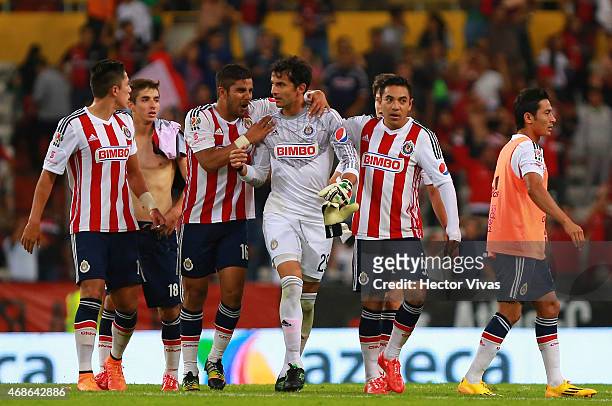 Players of Chivas celebrate with goalkeeper Luis Michel after he stopped a penalty during a match between Atlas and Chivas as part of 12th round...