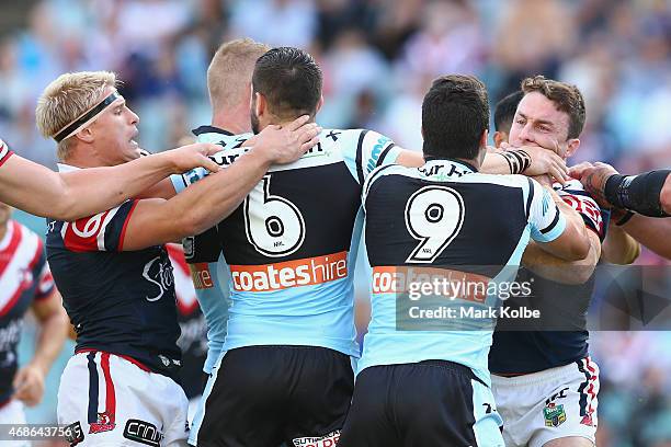 Michael Ennis of the Sharks and James Maloney of the Roosters scuffle during the round five NRL match between the Sydney Roosters and the Cronulla...