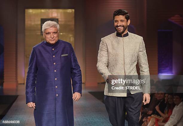 Indian Bollywood lyricist and scriptwriter Javed Akhtar and his son, Bollywood actor Farhan Akhtar, model creations by designer Manish Malhotra...