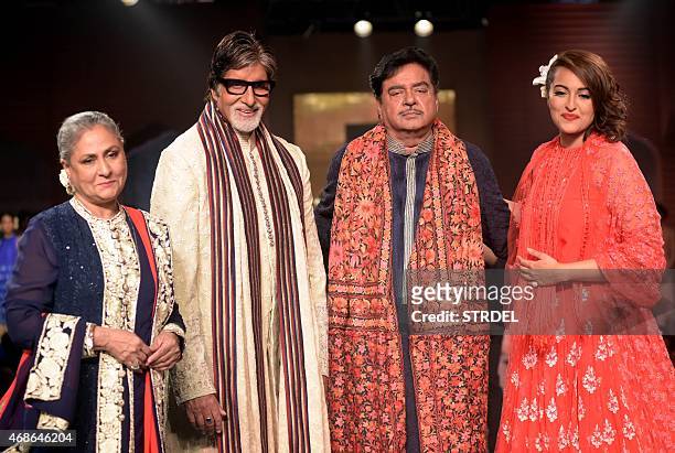 Indian Bollywood actors Jaya Bachchan , Amitabh Bachchan , Shatrughan Sinha and Sonakshi Sinha pose for a photograph during a charity fashion show in...