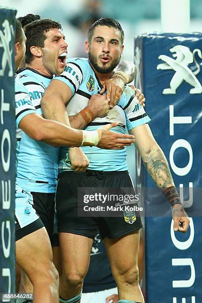 Michael Ennis of the Sharks celebrates with Jack Bird of the Sharks after he scored a try during the round five NRL match between the Sydney Roosters...