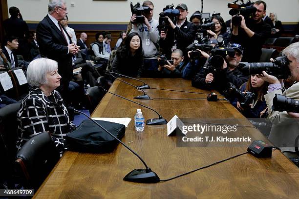 Janet Yellen, the new Federal Reserve Board chairwoman, takes a seat at the witness table before the House Financial Services Committee to give her...