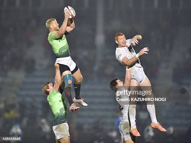 South Africa's Kyle Brown and England's James Rodwell fight for the ball during their final match at the Tokyo Rugby Sevens in Tokyo on April 5,...