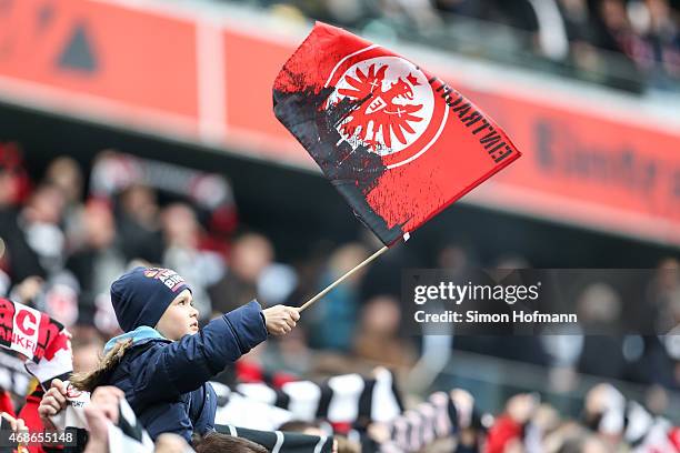 Young supporter of Frankfurt waves his flag during the Bundesliga match between Eintracht Frankfurt and Hannover 96 at Commerzbank-Arena on April 4,...