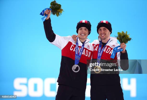 Silver medalist Mikael Kingsbury of Canada and gold medalist Alex Bilodeau of Canada celebrate on the podium during the medal ceremony for the for...