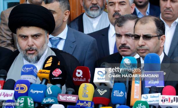 Iraqi Shiite cleric Moqtada al-Sadr speaks to the press after a meeting with Salim al-Juburi, the Parliament's speaker, alongside other parliament...