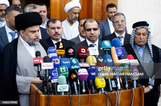 Iraqi Shiite cleric Moqtada al-Sadr speaks to the press after a meeting with Salim al-Juburi , the Parliament's speaker, alongside other parliament...