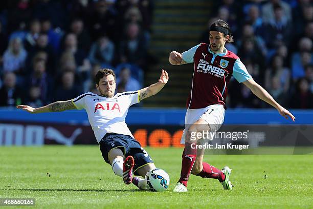 Ryan Mason of Spurs tackles George Boyd of Burnley during the Barclays Premier League match between Burnley and Tottenham Hotspur at Turf Moor on...