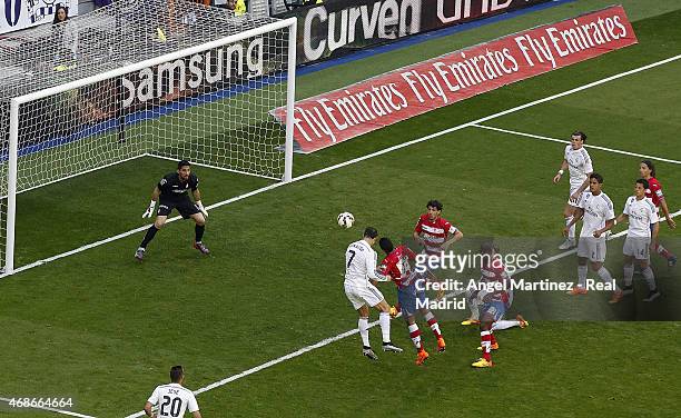 Cristiano Ronaldo of Real Madrid heads the ball to score his team's ninth goal during the La Liga match between Real Madrid CF and Granada CF at...
