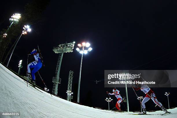 Michela Ponza of Italy, Magdalena Gwizdon of Poland and Fuyuko Suzuki of Japan compete in the Women's 10 km Pursuit during day four of the Sochi 2014...