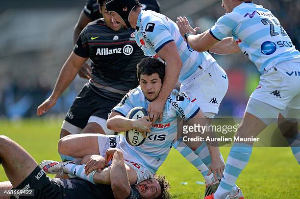 Brice Dulin of Racing Metro 92 is tackled by Jacques Burger of Saracens during the European Rugby Champions Cup quarter final match between Racing...