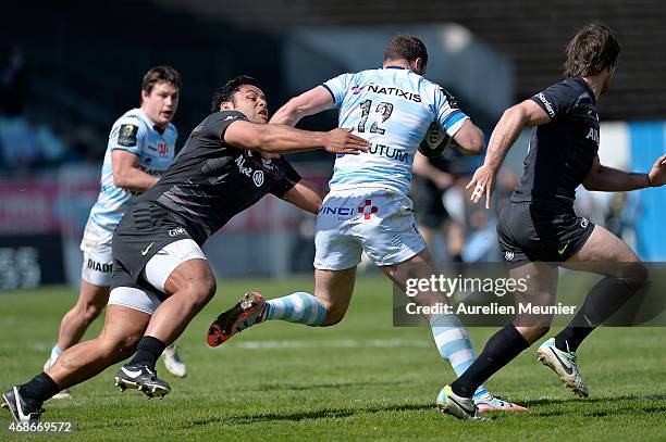 Jamie Roberts of Racing Metro 92 is tackled by Billy Vunipola of Saracens during the European Rugby Champions Cup quarter final match between Racing...