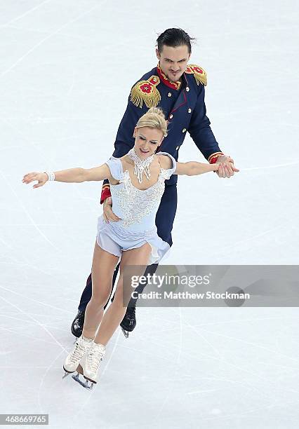 Tatiana Volosozhar and Maxim Trankov of Russia compete during the Figure Skating Pairs Short Program on day four of the Sochi 2014 Winter Olympics at...