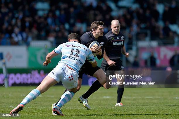 Alex Goode of Saracens is tackled by Jamie Roberts of Racing Metro 92 during the European Rugby Champions Cup quarter final match between Racing...