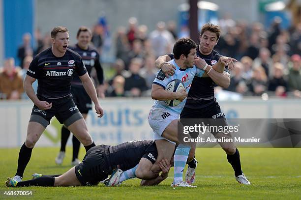 Brice Dulin of Racing Metro 92 is tackled by Chris Wyles of Saracens during the European Rugby Champions Cup quarter final match between Racing Metro...