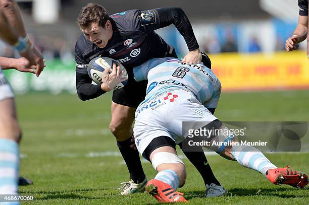 Alex Goode of Saracens is tackled by Wenceslas Lauret of Racing Metro 92 during the European Rugby Champions Cup quarter final match between Racing...
