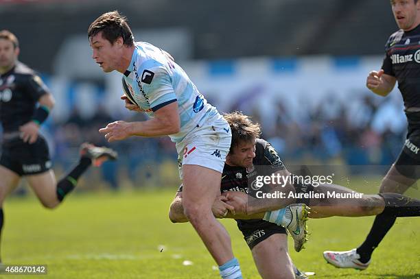 Henry Chavancy of Racing Metro 92 is tackled by Marcelo Bosch of Saracens during the European Rugby Champions Cup quarter final match between Racing...