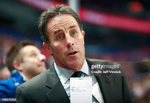 Assistant coach Doug Lidster of the Vancouver Canucks looks on from the bench during their NHL game against the Dallas Stars at Rogers Arena March...