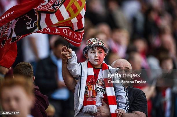Sunderland fan waves a flag prior to kick off of the Barclays Premier League match between Sunderland FC and Newcastle United at The Stadium of Light...