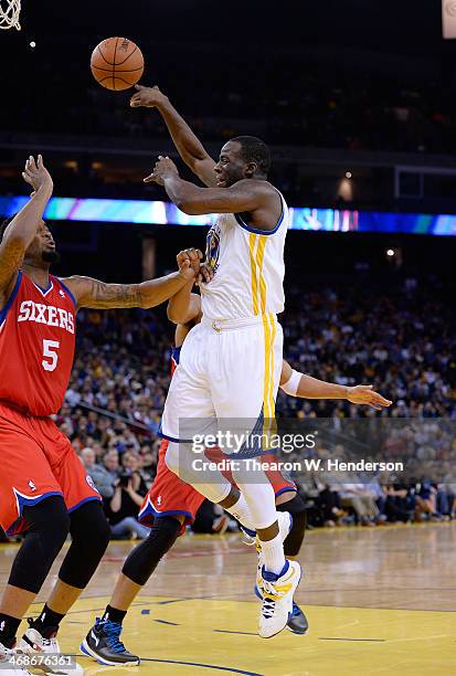 Draymond Green of the Golden State Warriors passes the ball over Arnett Moultrie the Philadelphia 76ers at ORACLE Arena on February 10, 2014 in...