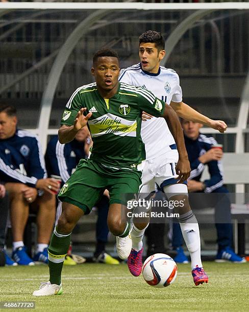 Alvas Powell of the Portland Timbers runs with the ball after getting past Matas Laba of the Vancouver Whitecaps FC in MLS action on March 28, 2015...