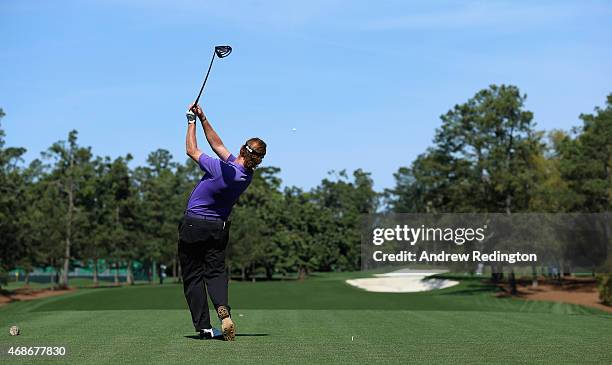 Miguel Angel Jimenez of Spain hits his tee-shot on the first hole during practice on Drive, Chip and Putt Championship Day at Augusta National Golf...