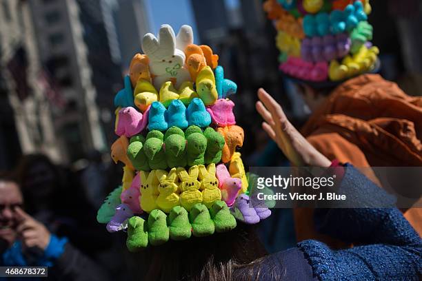 Woman steadies her hat made of marshmallow peeps as she makes her way along Fifth Avenue during the annual Easter Parade April 5, 2015 in New York...