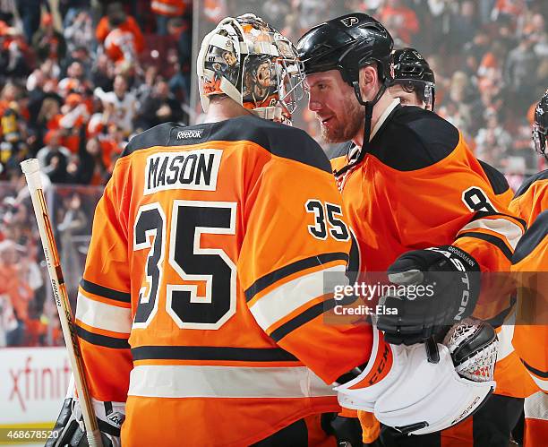 Steve Mason of the Philadelphia Flyers is congratulated by Nicklas Grossmann after the game against the Pittsburgh Penguins on April 5, 2015 at the...