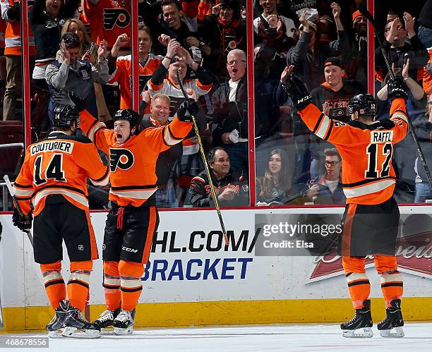 Ryan White of the Philadelphia Flyers celebrates his goal in the third period with teammates Sean Couturier and Michael Raffl in the third period...