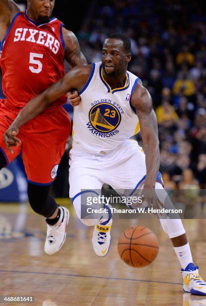 Draymond Green of the Golden State Warriors drives towards the basket on Arnett Moultrie of the Philadelphia 76ers at ORACLE Arena on February 10,...