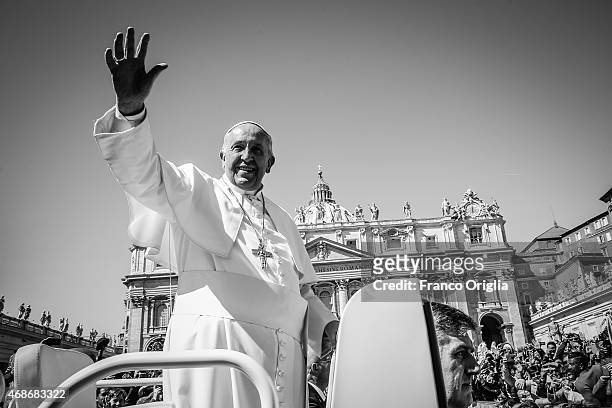 Pope Francis waves to the faithful as he leaves St. Peter's Square at the the end of Palm Sunday Mass on March 29, 2015 in Vatican City, Vatican....
