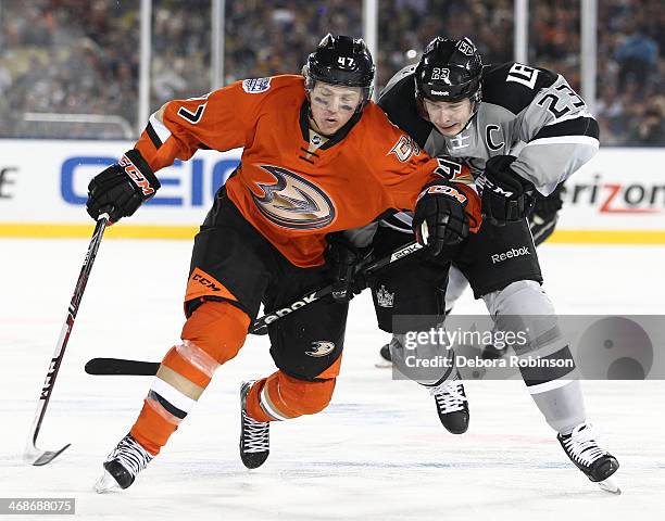 Hampus Lindholm of the Anaheim Ducks battles for position against Dustin Brown of the Los Angeles Kings during the 2014 Coors Light NHL Stadium...