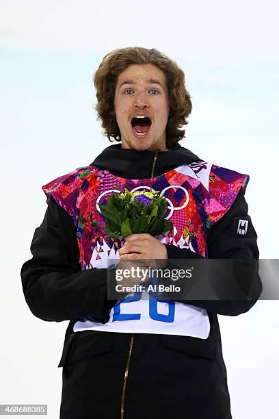 Gold medalist Iouri Podladtchikov of Switzerland celebrates on the podium during the flower ceremony for the Snowboard Men's Halfpipe Finals on day...