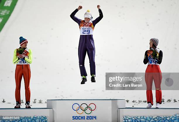 Silver medalist Daniela Iraschko-Stolz of Austria, gold medalist Carina Vogt of Germany and bronze medalist Coline Mattel of France on the podium...