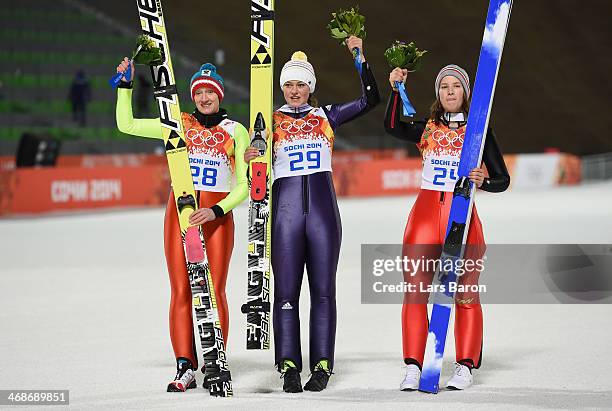 Silver medalist Daniela Iraschko-Stolz of Austria, gold medalist Carina Vogt of Germany and bronze medalist Coline Mattel of France on the podium...