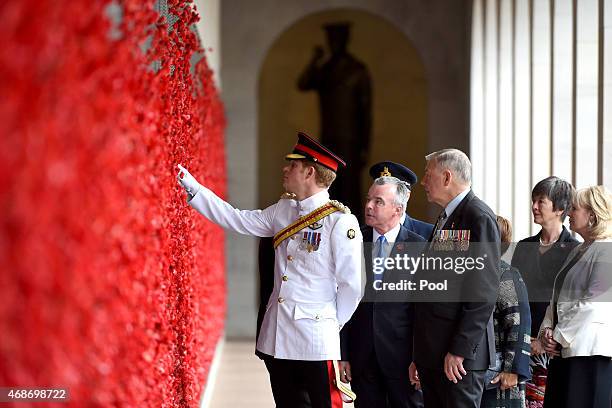 Prince Harry, Director of the Australian War Memorial Brendan Nelson and Chair of the Australian War Memorial Rear Admiral Ken Doolan take a look at...