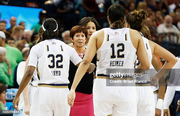 Head coach Muffet McGraw of the Notre Dame Fighting Irish and her team react in the second half against the South Carolina Gamecocks during the NCAA...