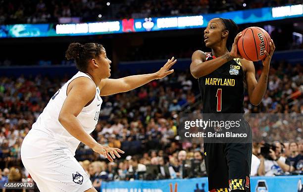 Laurin Mincy of the Maryland Terrapins looks to pass against Kaleena Mosqueda-Lewis of the Connecticut Huskies in the first half during the NCAA...