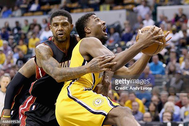 Solomon Hill of the Indiana Pacers is fouled by Udonis Haslem of the Miami Heat at Bankers Life Fieldhouse on April 5, 2015 in Indianapolis, Indiana....
