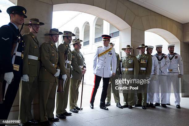 Prince Harry shakes hands with members of the 'Catafalque Party' during a visit to the Australian War Memorial on April 6, 2015 in Canberra,...