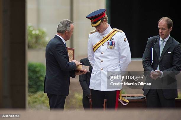 Prince Harry receives gifts from Dr Brendan Nelson at the Australian War Memorial on April 6, 2015 in Canberra, Australia. Prince Harry, or Captain...