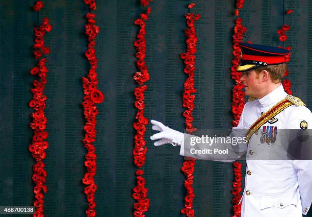 Prince Harry walks along the Roll of Honour with officials during a visit to the Australian War Memorial on April 6, 2015 in Canberra, Australia....