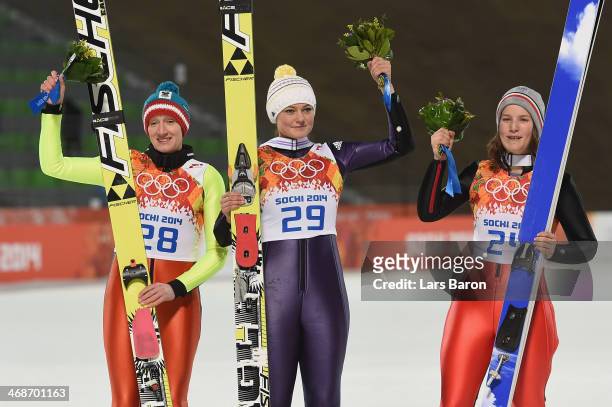 Silver medalist Daniela Iraschko-Stolz of Austria, gold medalist Carina Vogt of Germany and bronze medalist Coline Mattel of France pose for...