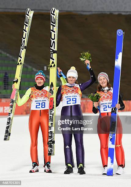 Silver medalist Daniela Iraschko-Stolz of Austria, gold medalist Carina Vogt of Germany and bronze medalist Coline Mattel of France pose for...