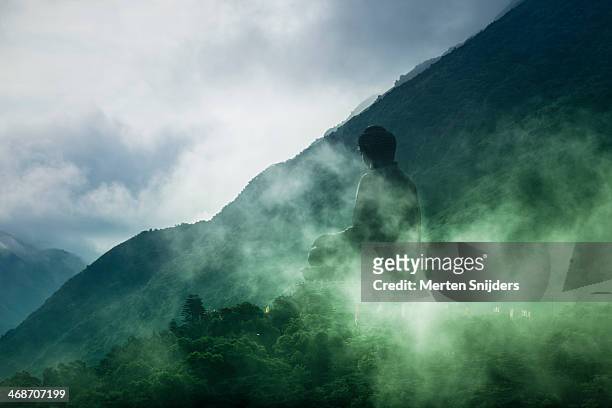 tian tan buddha on hill in clouds - lantau stock pictures, royalty-free photos & images