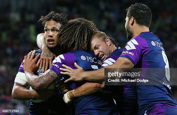Will Chambers of the Storm celebrate a try with Kevin Proctor and Ryan Hinchcliffe during the round five NRL match between the Melbourne Storm and...